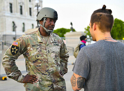 Army Master Sgt. Acie Matthews Jr., an equal employment opportunity advisor with the Minnesota Army National Guard, peacefully engages with a protester at the Minnesota state capitol in St. Paul, June 1.
